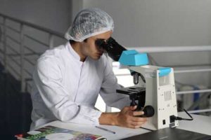 EU Update Medical Device Translation - Person Looking Through Microscope